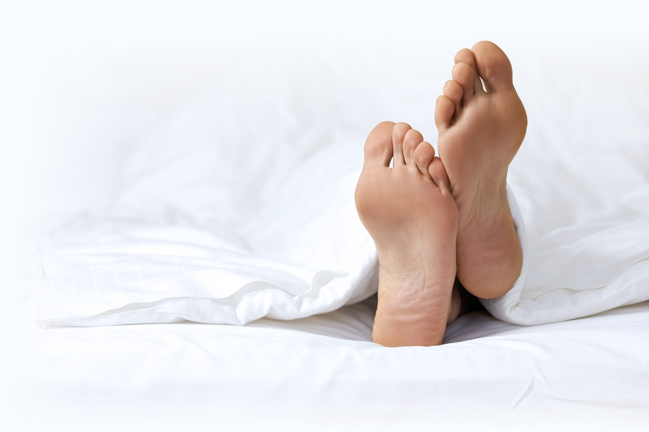 person's foot in bed